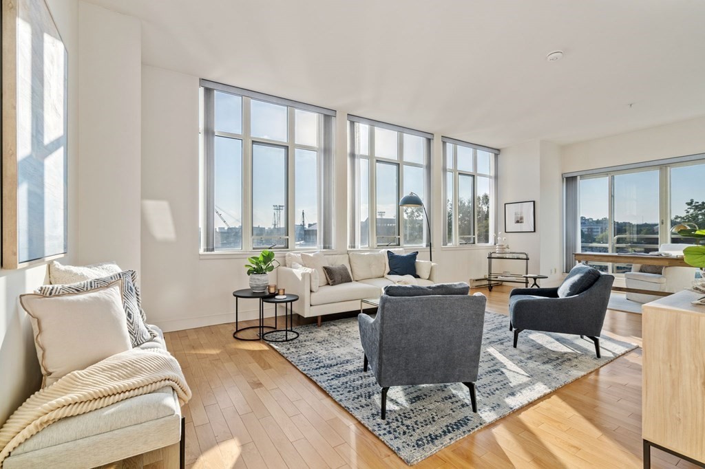a living room with furniture and large windows