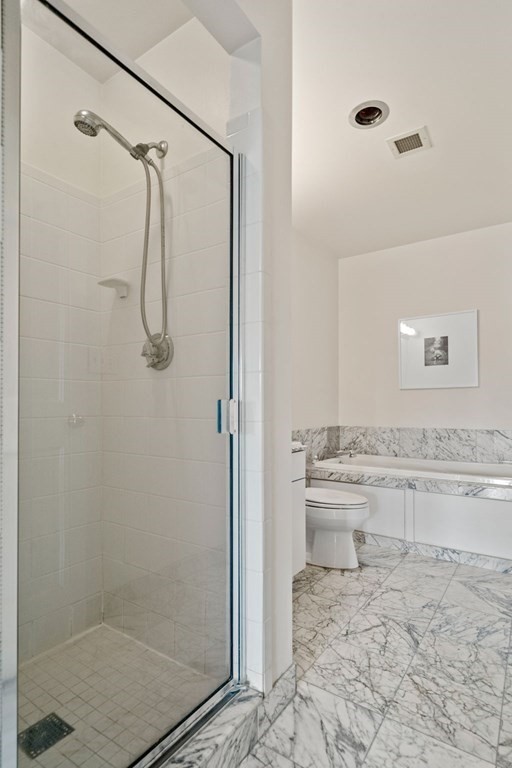 197 8th Street, Unit 330 Boston, MA 02129 - Photo 18 of 39 a bathroom with a granite countertop shower a toilet and a sink