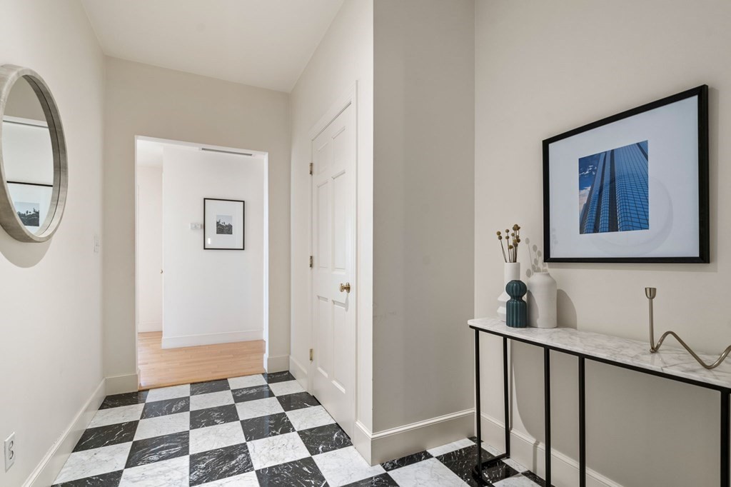 197 8th Street, Unit 330 Boston, MA 02129 - Photo 20 of 39 a hallway with a black white checkered floor with a white walls