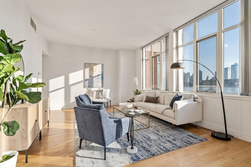 197 8th Street, Unit 330 Boston, MA 02129 - Photo 3 of 39 a living room with furniture large window and wooden floor