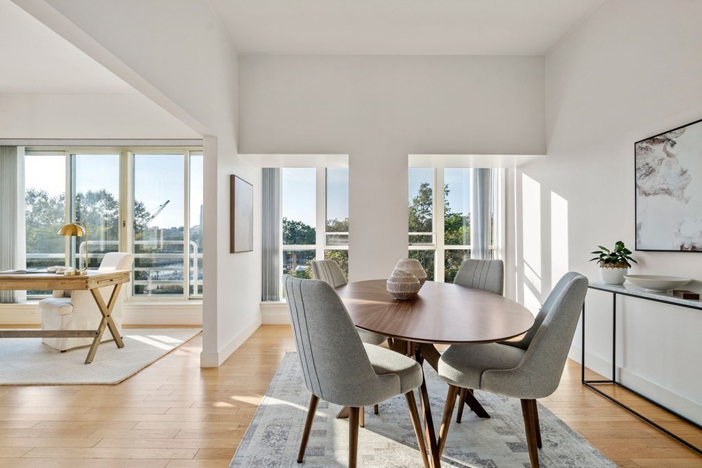 197 8th Street, Unit 330 Boston, MA 02129 - Photo 5 of 39 a view of a dining room with furniture wooden floor and a potted plant