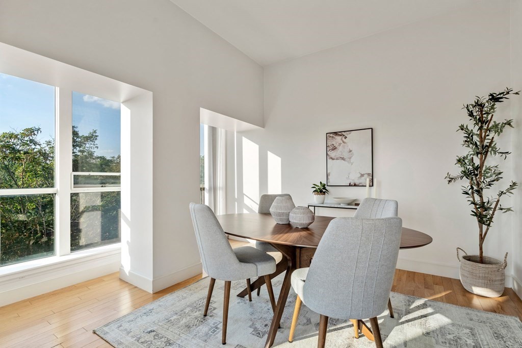 197 8th Street, Unit 330 Boston, MA 02129 - Photo 7 of 39 a dining room with furniture window and wooden floor