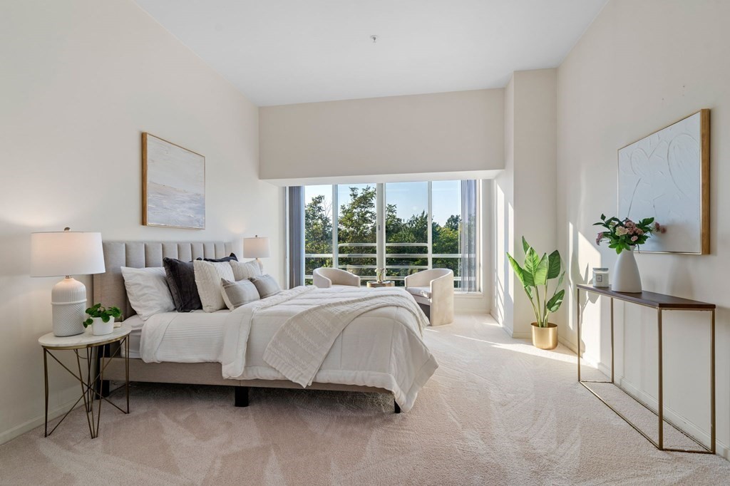 197 8th Street, Unit 330 Boston, MA 02129 - Photo 8 of 39 a spacious bedroom with a bed and a large window