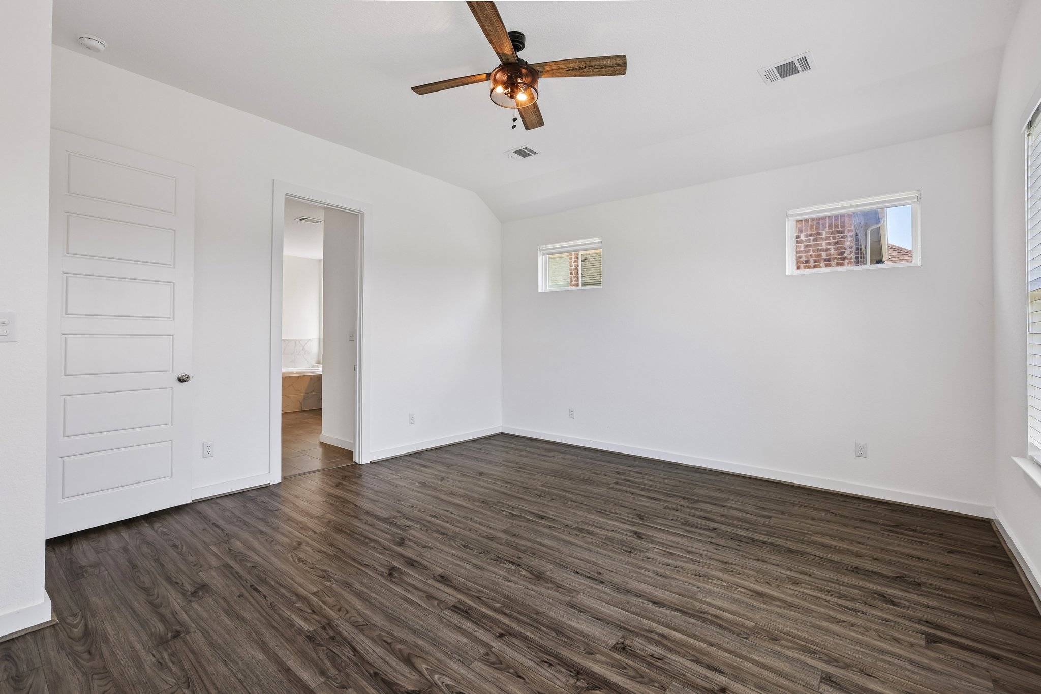 317 Independence Drive Kyle, TX 78640 - Photo 18 of 40 an empty room with wooden floor ceiling fan