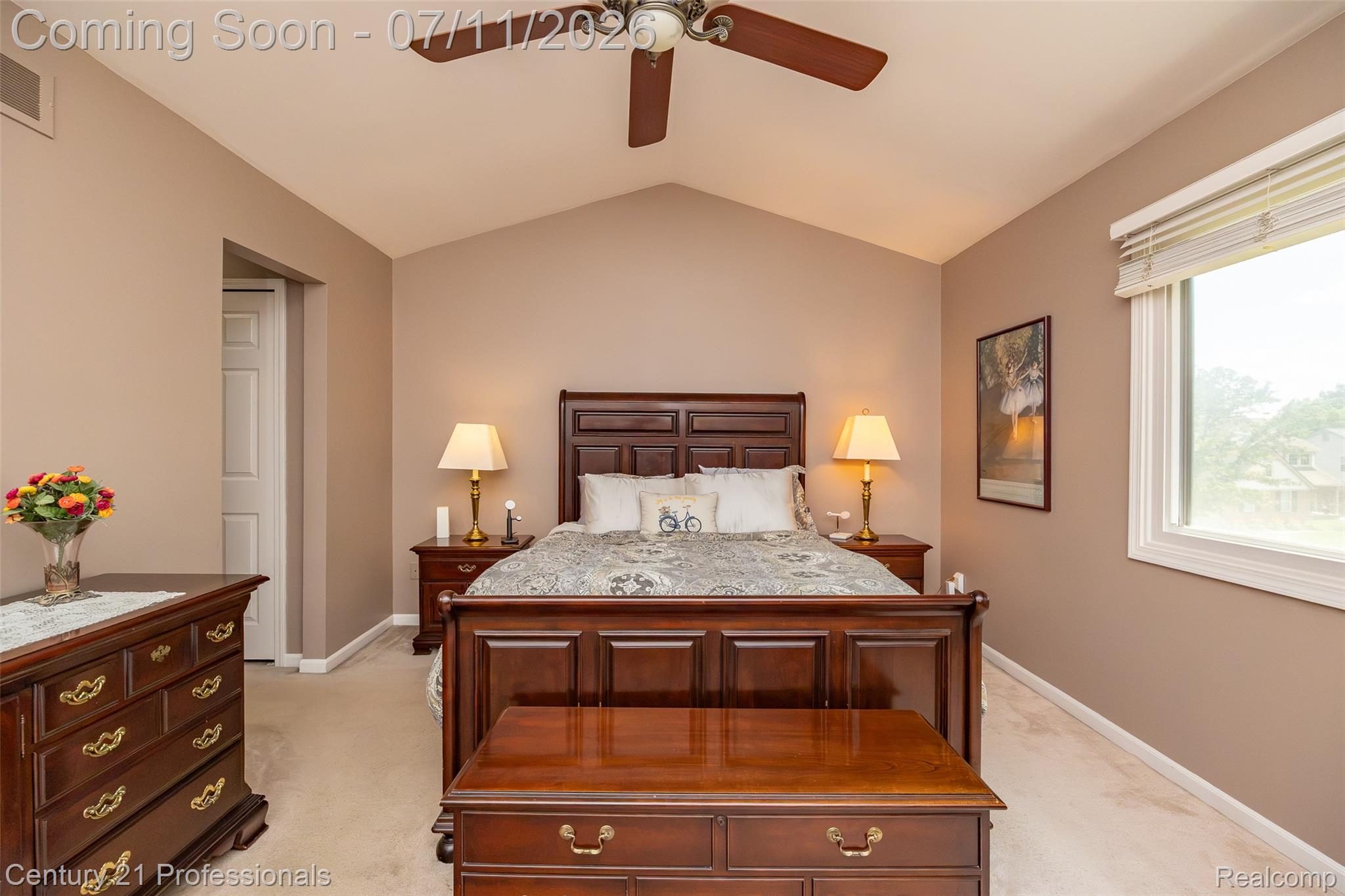 689 Woodfield Way Rochester, MI 48307 - Photo 23 of 61 Vaulted ceiling bedroom with a ceiling fan light fixture, neutral wall color, and a large window with blinds