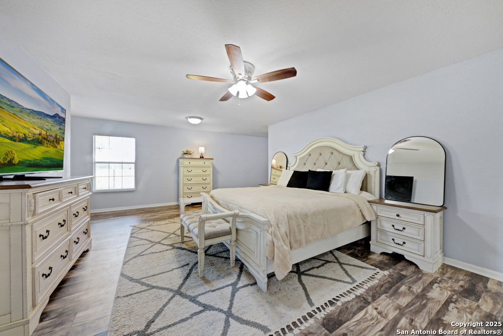 1510 Timmermann Road Seguin, TX 78155 - Photo 14 of 32 a bedroom with a bed and a flat screen tv