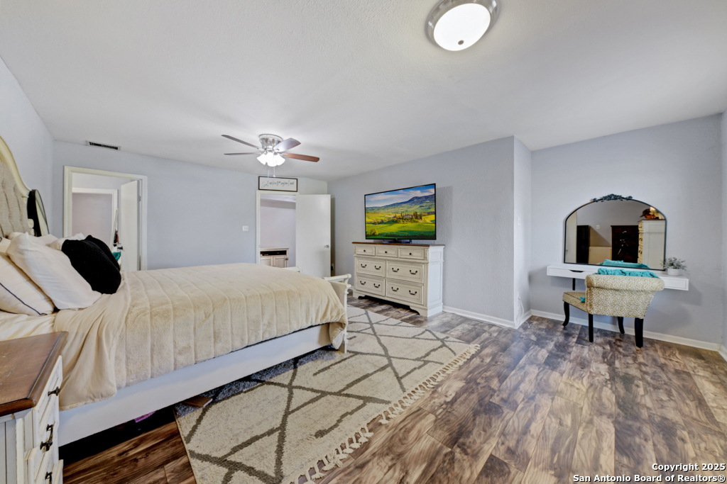 1510 Timmermann Road Seguin, TX 78155 - Photo 15 of 32 a bedroom with a bed and a chandelier