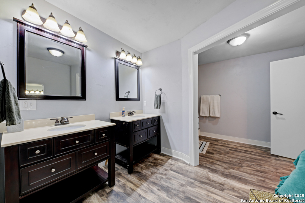 1510 Timmermann Road Seguin, TX 78155 - Photo 16 of 32 a spacious bathroom with a double vanity sink a mirror and a toilet