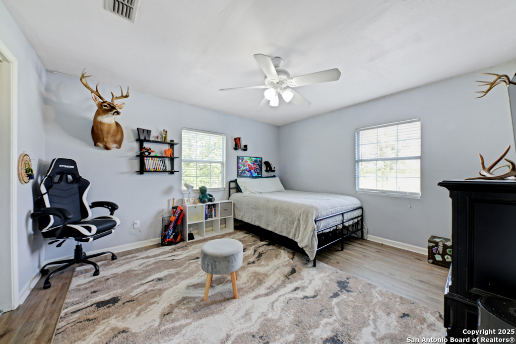 1510 Timmermann Road Seguin, TX 78155 - Photo 18 of 32 a bedroom with a bed gym equipment and a window