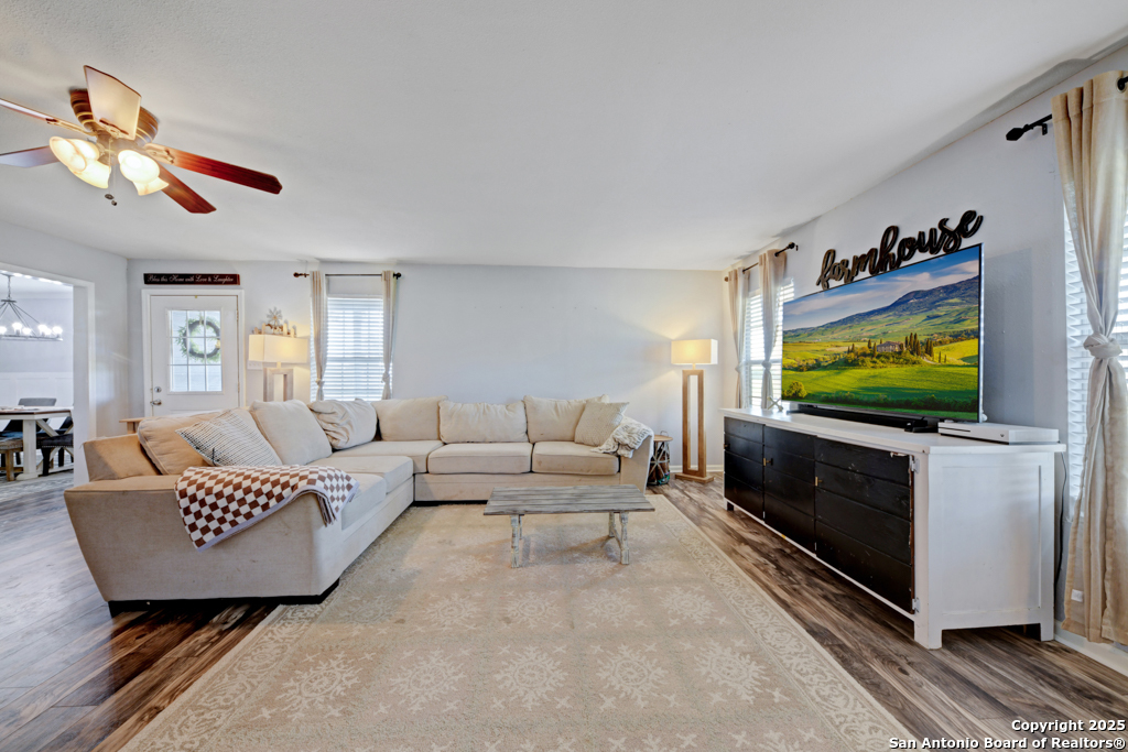1510 Timmermann Road Seguin, TX 78155 - Photo 3 of 32 a living room with a couch a window and a flat screen tv