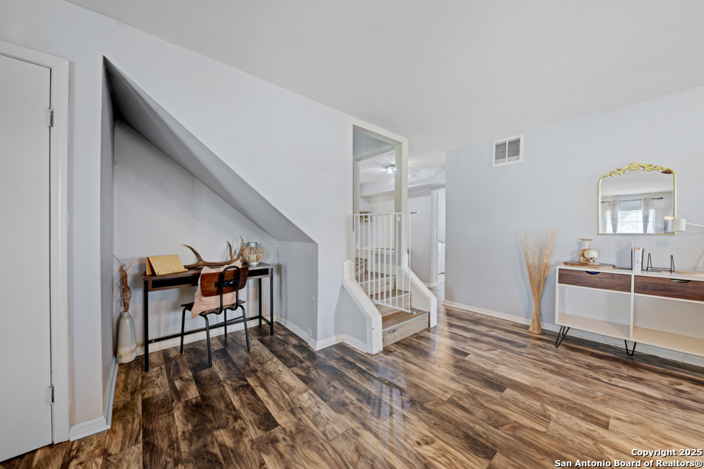 1510 Timmermann Road Seguin, TX 78155 - Photo 5 of 32 a workspace with wooden floor and furniture