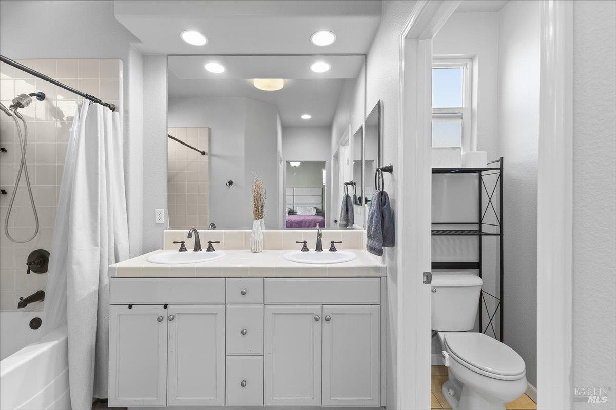 2067 San Miguel Avenue Santa Rosa, CA 95403 - Photo 18 of 38 a bathroom with a double vanity sink toilet and shower