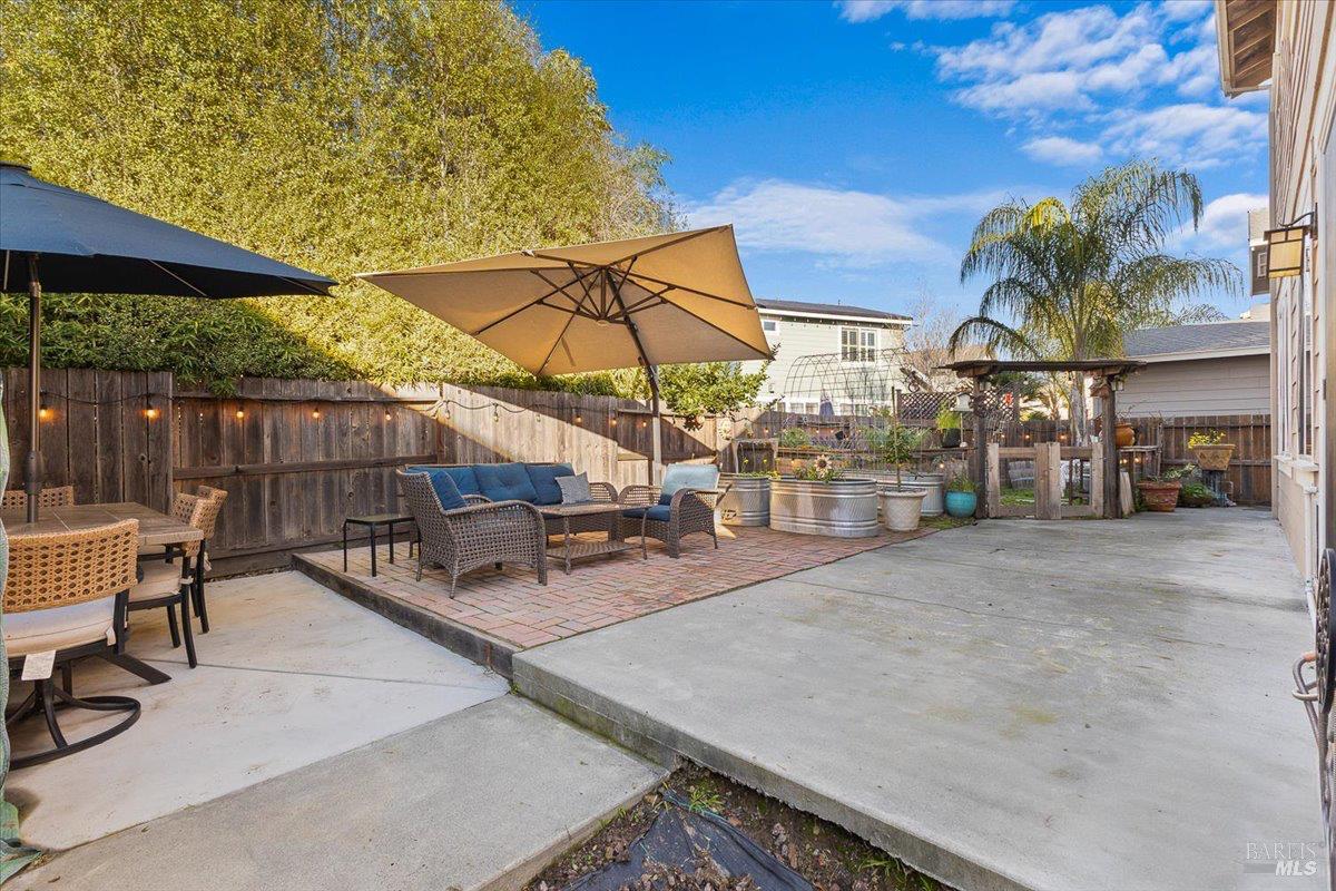 2067 San Miguel Avenue Santa Rosa, CA 95403 - Photo 27 of 38 a view of a patio with a table and chairs under an umbrella