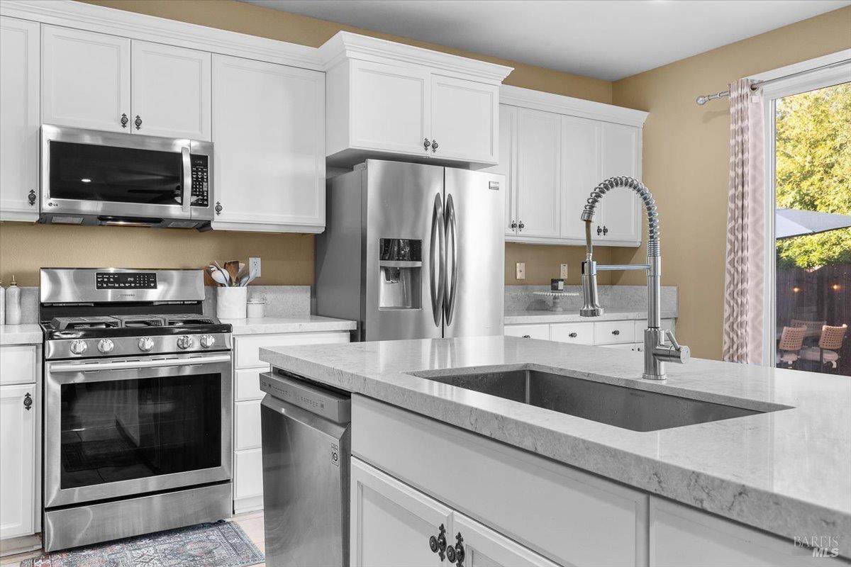 2067 San Miguel Avenue Santa Rosa, CA 95403 - Photo 8 of 38 a kitchen with stainless steel appliances granite countertop a sink stove and refrigerator