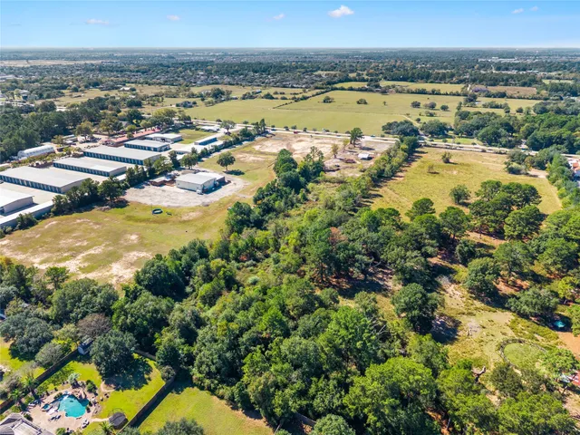 an aerial view of a residential houses with outdoor space