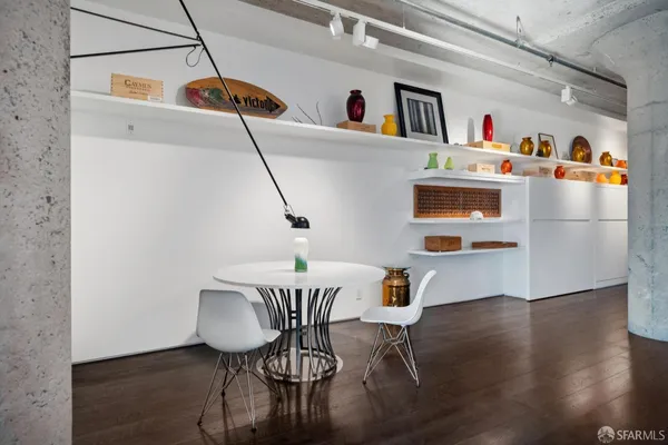 a view of a kitchen that has a wooden floor