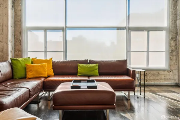 a view of a city from a balcony with furniture