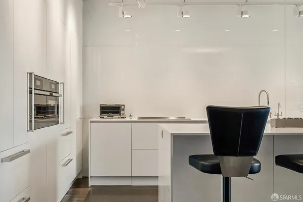 a kitchen with a sink and a refrigerator
