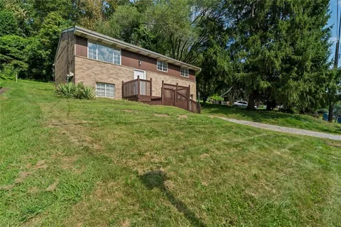 a view of a backyard with barn and large trees