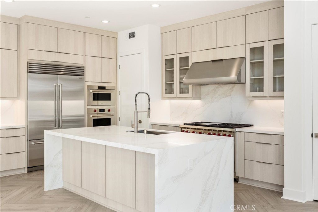 164 Apron Irvine, CA 92618 - Photo 14 of 67 a kitchen with stainless steel appliances granite countertop white cabinets and a refrigerator
