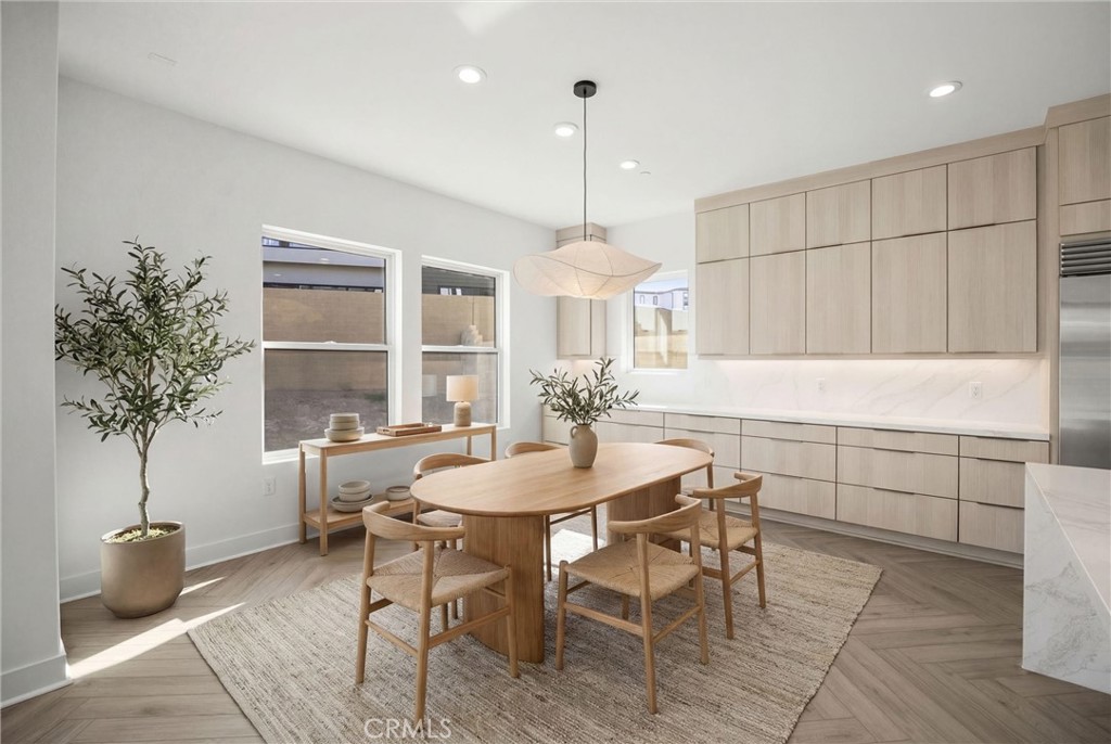 164 Apron Irvine, CA 92618 - Photo 17 of 67 a kitchen with a table and chairs in it