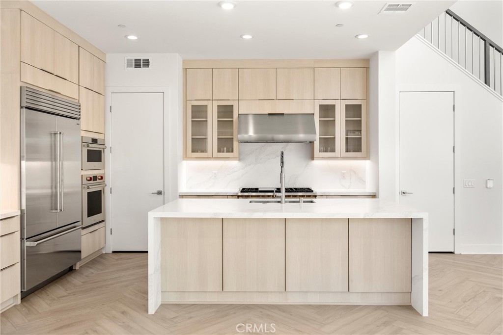 164 Apron Irvine, CA 92618 - Photo 18 of 67 a kitchen with stainless steel appliances granite countertop a stove a refrigerator and a refrigerator