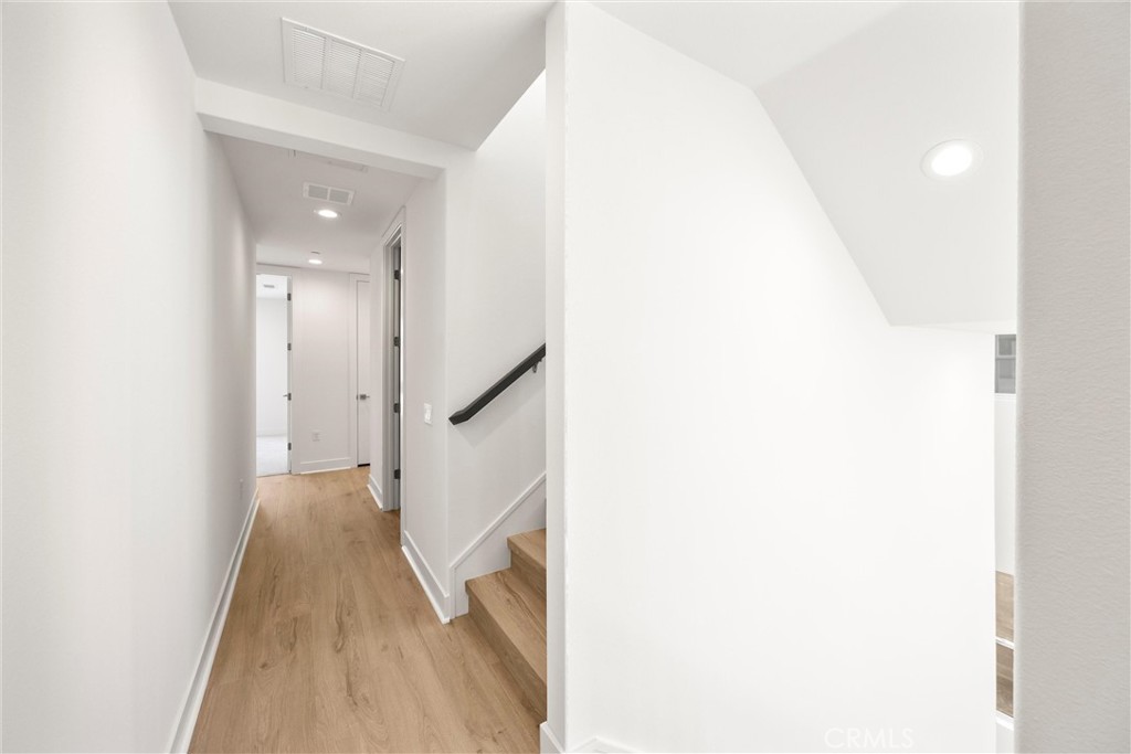 164 Apron Irvine, CA 92618 - Photo 23 of 67 a view of a hallway with wooden floor