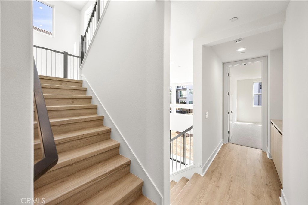 164 Apron Irvine, CA 92618 - Photo 24 of 67 a view of a hallway with wooden floor and entryway