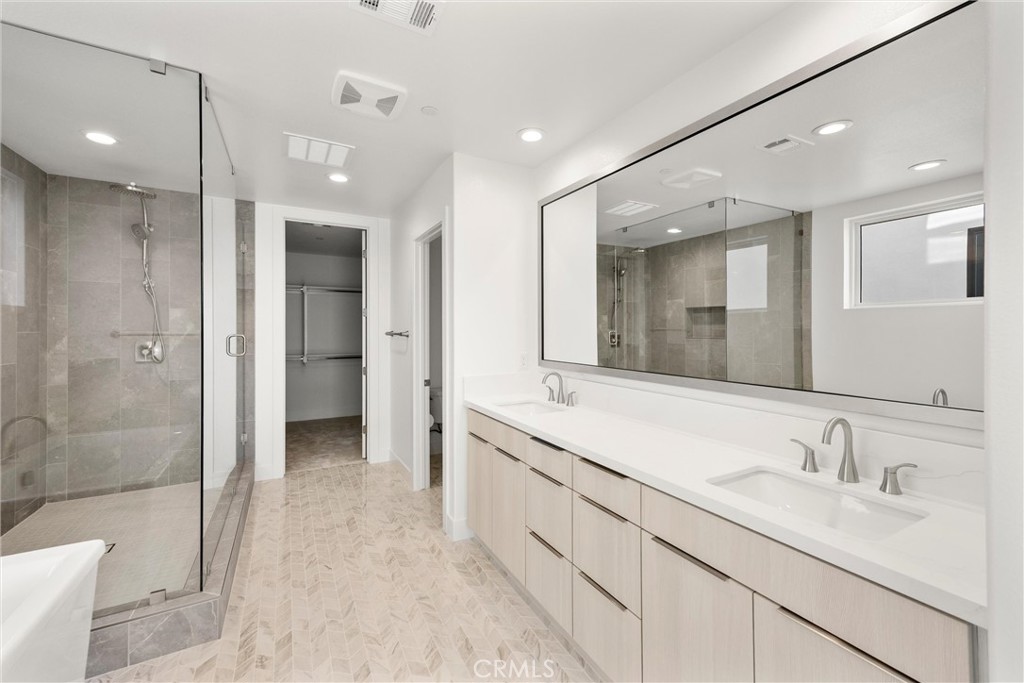 164 Apron Irvine, CA 92618 - Photo 28 of 67 a bathroom with a double vanity sink mirror and shower