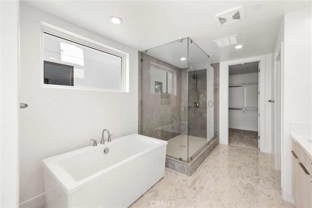 164 Apron Irvine, CA 92618 - Photo 29 of 67 a spacious bathroom with a bathtub and a shower