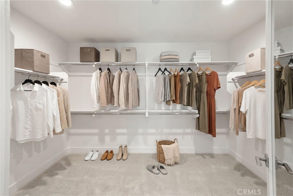 164 Apron Irvine, CA 92618 - Photo 31 of 67 a view of walk in closet with clothes and shoes