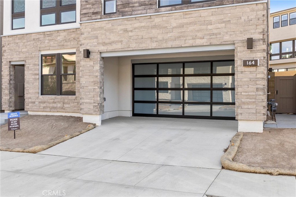164 Apron Irvine, CA 92618 - Photo 4 of 67 a front view of a house with a empty parking space