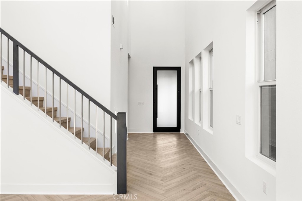 164 Apron Irvine, CA 92618 - Photo 6 of 67 a view of a hallway with wooden floor and staircase