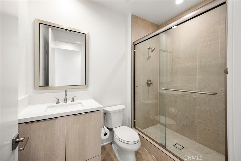 164 Apron Irvine, CA 92618 - Photo 9 of 67 a bathroom with a shower sink vanity mirror and toilet