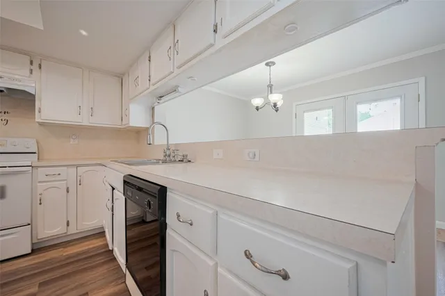 a view of a kitchen with wooden floor and electronic appliances