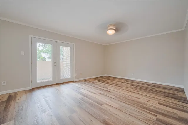 wooden floor in an empty room with a window