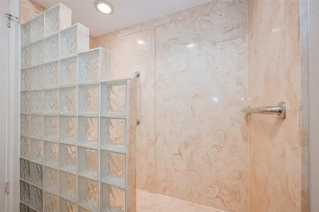 a white toilet sitting next to a shower