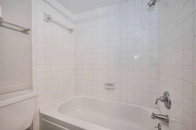 a bathroom with a bathtub sink vanity and mirror
