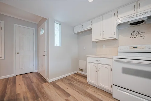 a kitchen with granite countertop white cabinets and white appliances