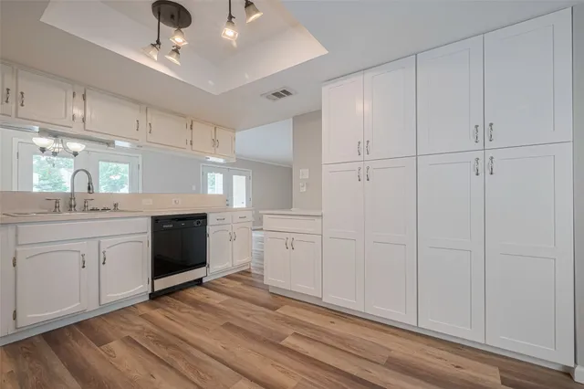 a kitchen with white cabinets and white appliances