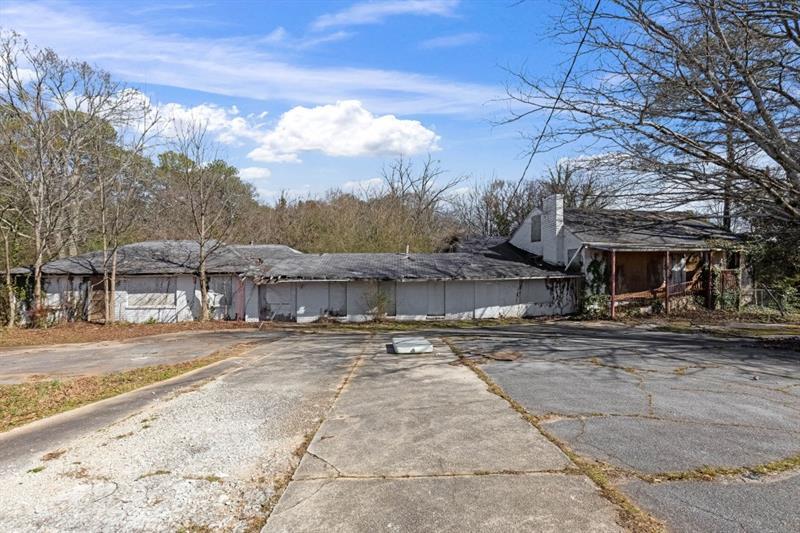 2076 Windy Hill Road Decatur, GA 30032 - Photo 11 of 20 a view of a big house with a road and a yard
