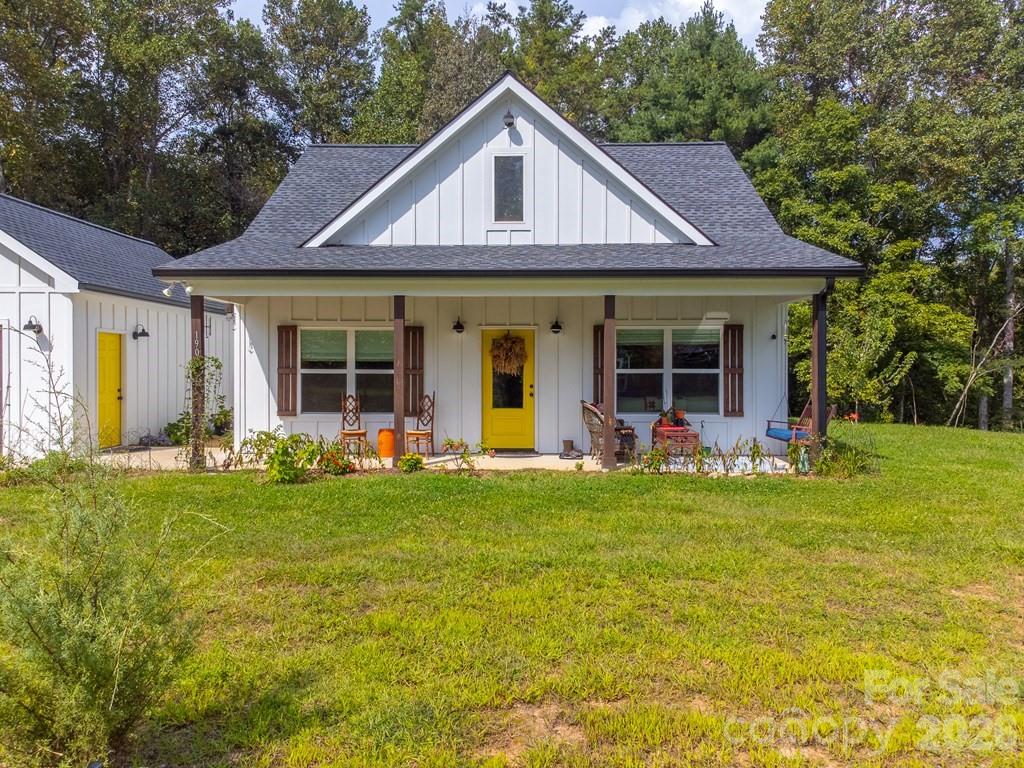 190 Fort Hembree Road Hayesville, NC 28904 - Photo 2 of 18 a front view of a house with a garden and porch