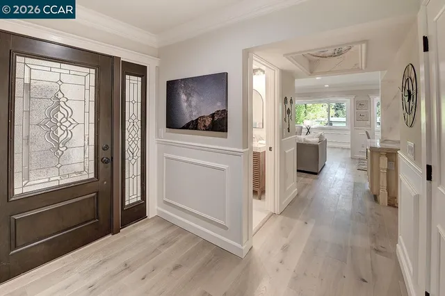 a view of a living room hardwood floor and a window