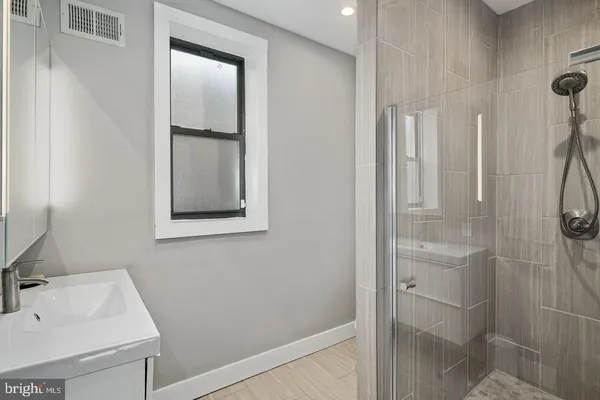 a bathroom with a sink and mirror