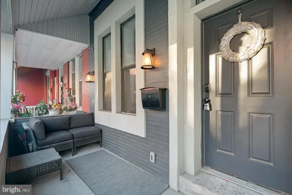 a living room with furniture and a glass door