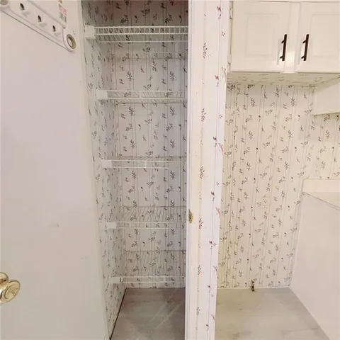 an empty room with furniture and a ceiling fan