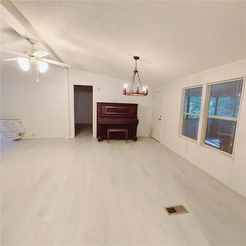 an empty room with a fireplace and fan
