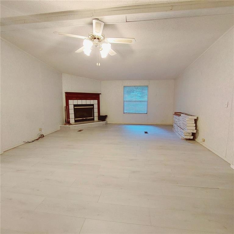 281 Mockingbird Drive Monticello, GA 31064 - Photo 15 of 42 an empty room with a fireplace and fan