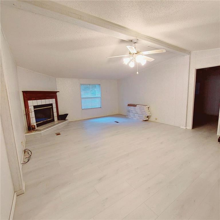 281 Mockingbird Drive Monticello, GA 31064 - Photo 16 of 42 a view of empty room with window and fireplace