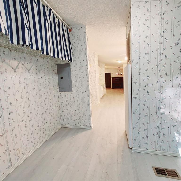 281 Mockingbird Drive Monticello, GA 31064 - Photo 20 of 42 a view of a livingroom with wooden floor and kitchen space